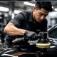 Technician polishing a vehicle